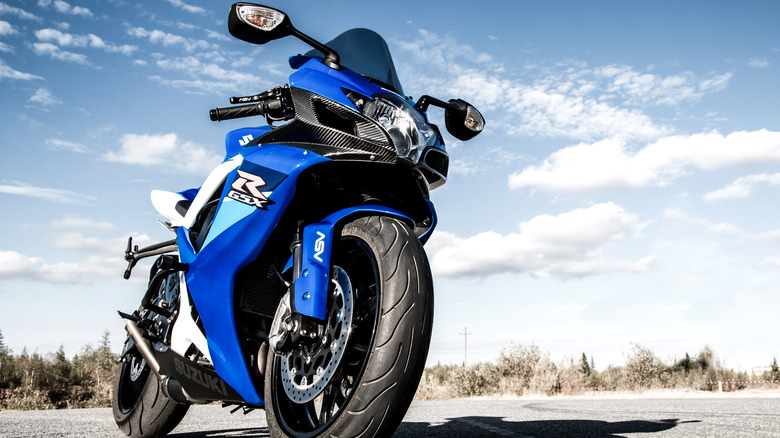 A blue motorcycle set against the blue sky