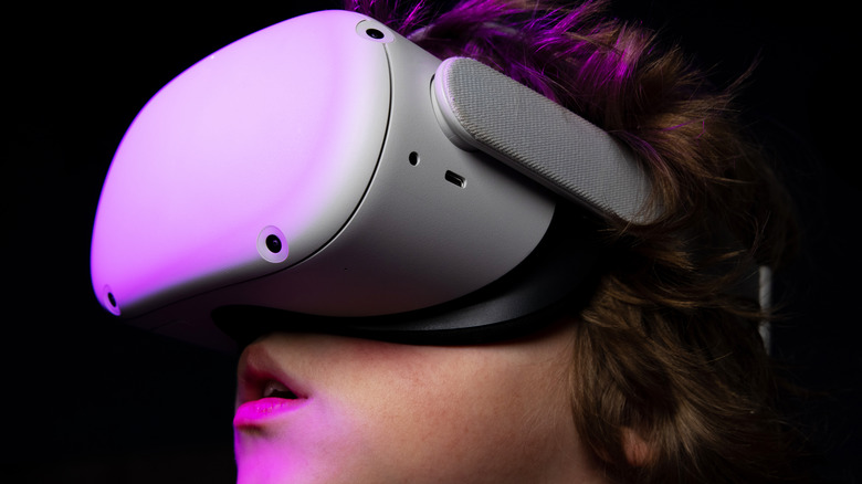 Person wearing Meta Quest VR headset.