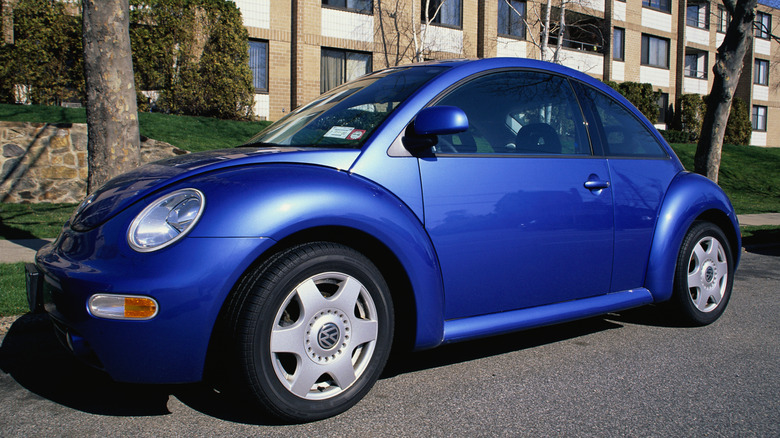 New model blue VW Beetle parked on a street