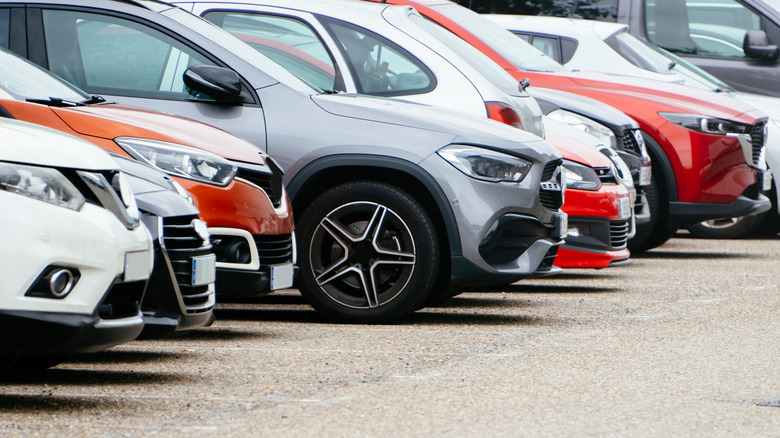 A row of new cars, showing different colors of vehicles.