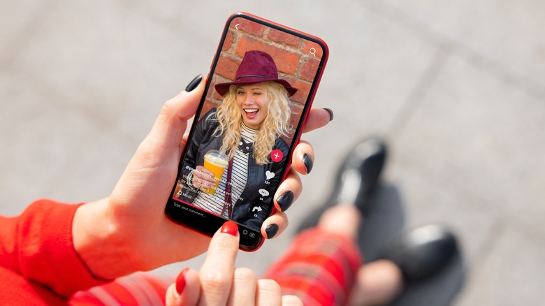 Person using TikTok smartphone