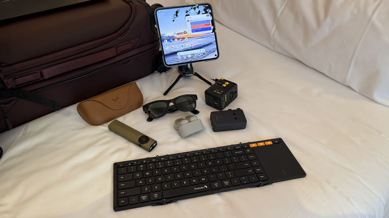 multiple tech items on a bed