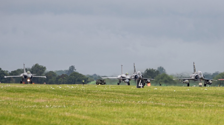 A couple of Rafales take off alongside a couple of MIrage-2000s