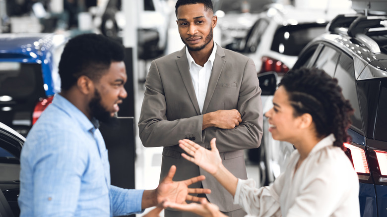 Angry couple at a car dealership