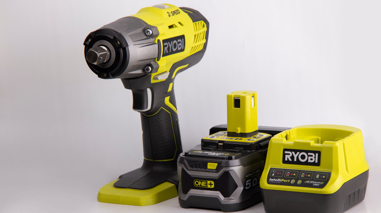cordless Ryobi power tool with a charger and a battery next to it