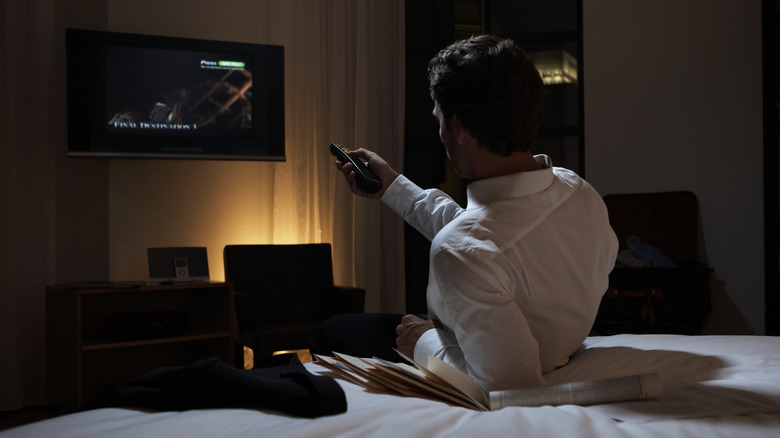 person watching hotel room TV
