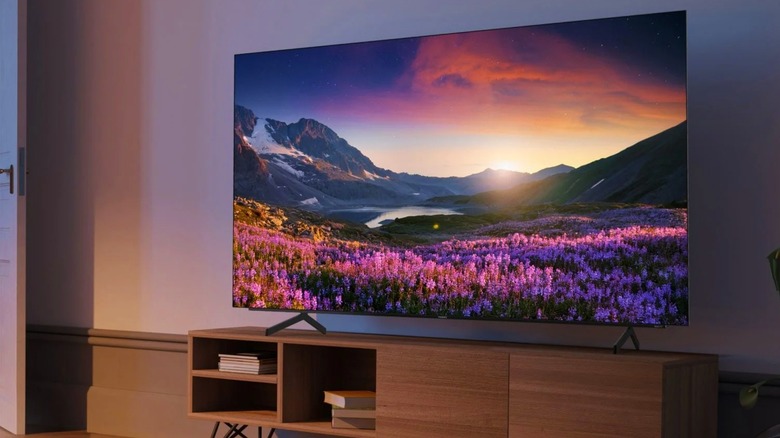 A Philips 65 Class 974 Series 4K OLED TV showing a sunset.