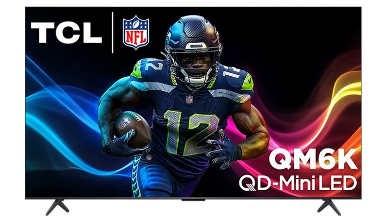 A TCL 75QM6K TV on a white background, showing an NFL player running
