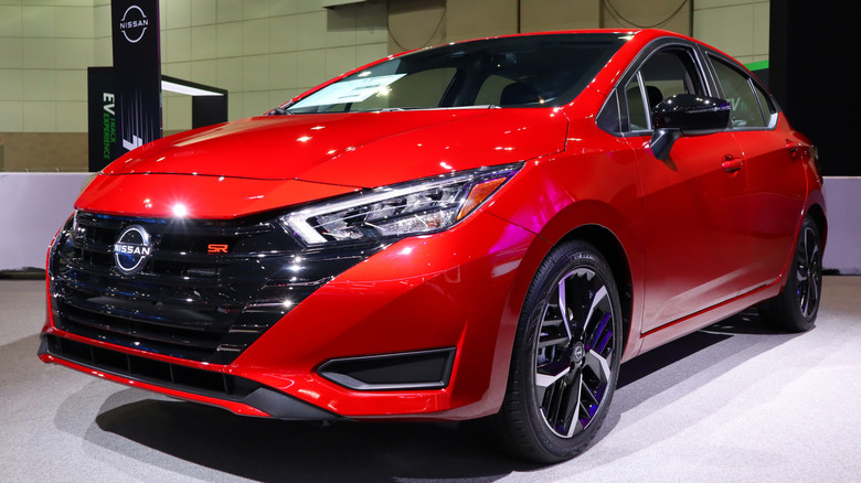 Red Nissan Versa at a car show