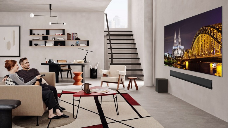 A couple watching a movie on an LG G5 OLED TV