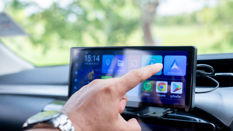 Person interacting with a car's infotainment display
