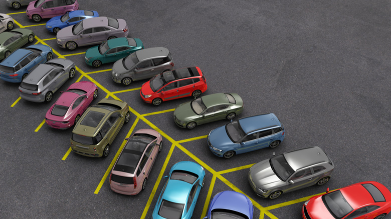 Cars parked across a yellow parking lot