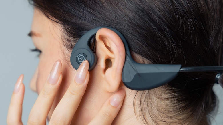 Woman wearing bone conduction headphones