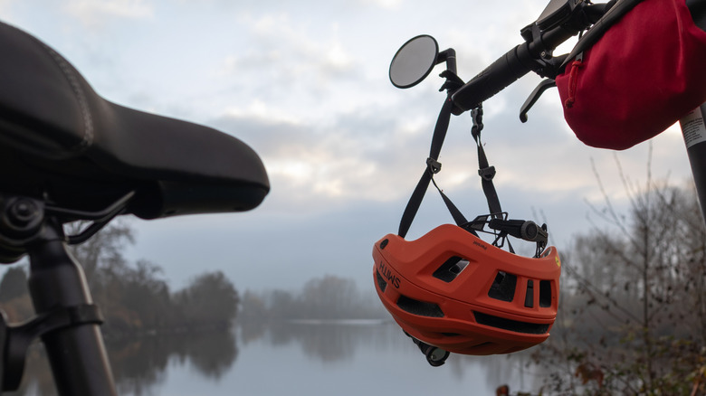 Helmet hanging from bicycle handle