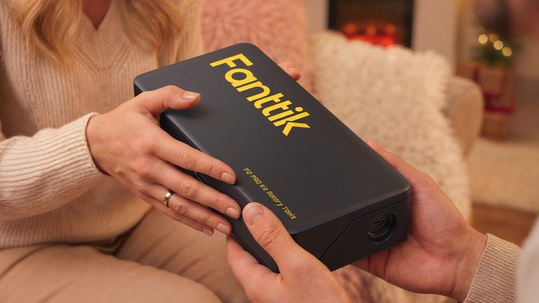 Person giving a Fanttik tool as a present