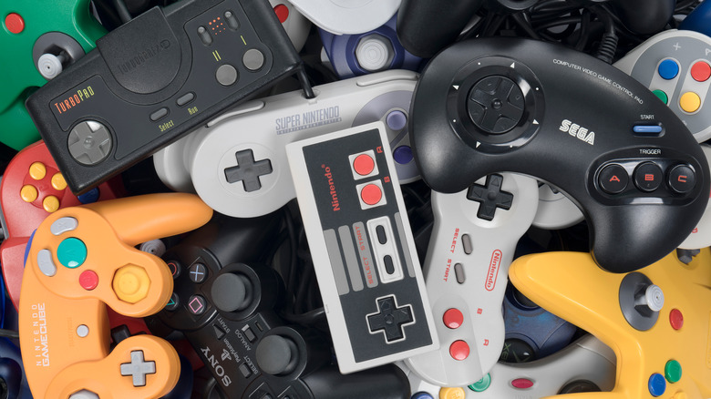 Video game controllers stacked together.