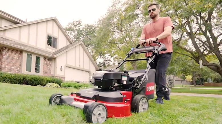 Person using Toro mower to cut their grass