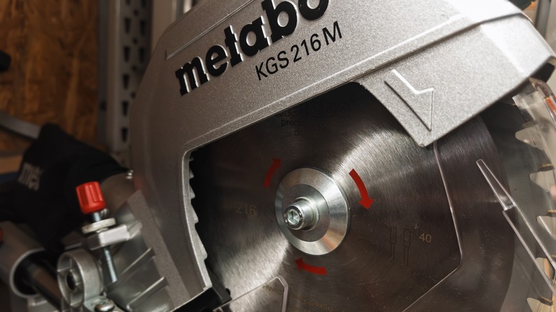 A closeup of a Metabo saw with the code "KGS 216M" written on it