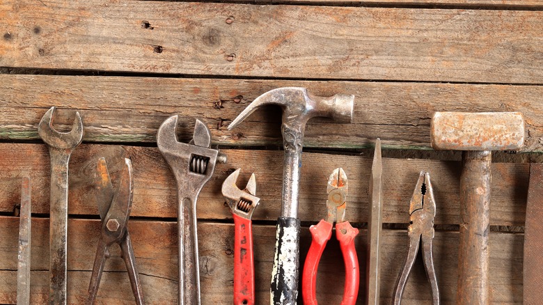 Old tools against a wooden backdrop
