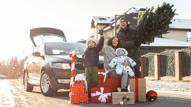 A family with gifts around their car