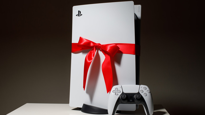 A Playstation 5 wrapped in a bow sits