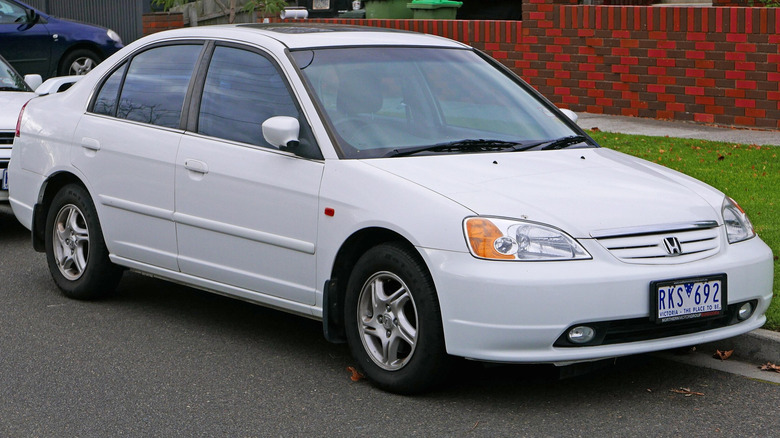 2002 Honda Civic GLi sedan parked on roadside with other cars in the background