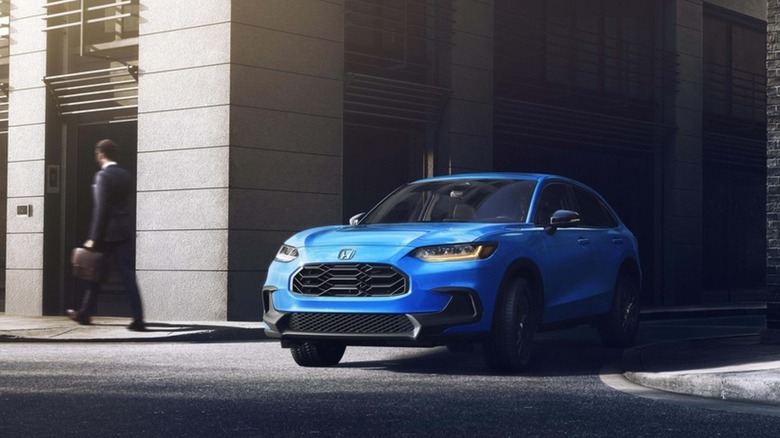 A Honda HR-V driving out of an alley.