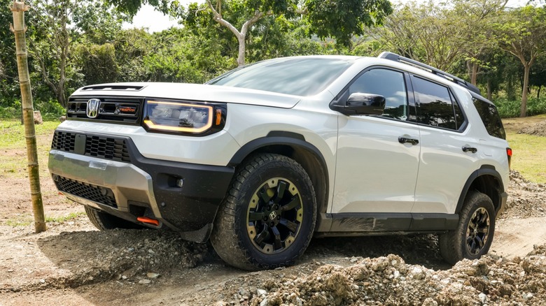 A Honda Passport climbing up a small trail.