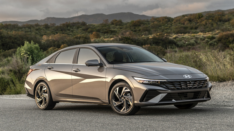 Gray Hyundai Elantra parked in front of hilly terrain