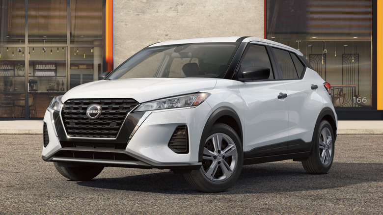 White Nissan Kicks Play parked in front of a building