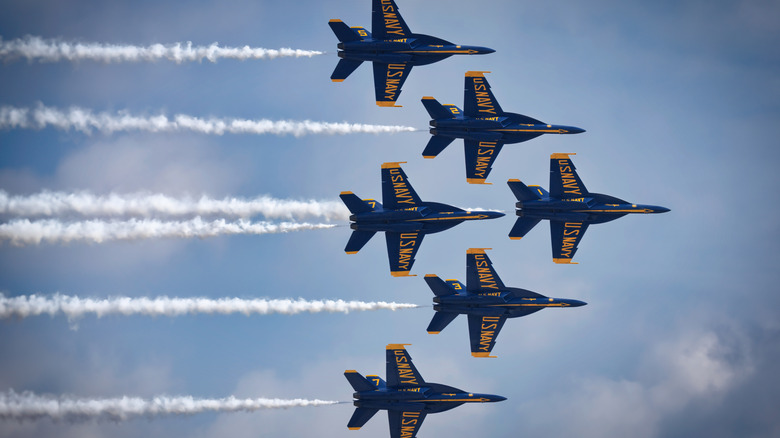 Six Blue Angels F/A-18 Super Hornets flying in a tight formation