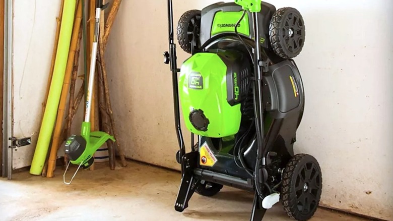 Greenworks lawnmower sitting inside of a garage