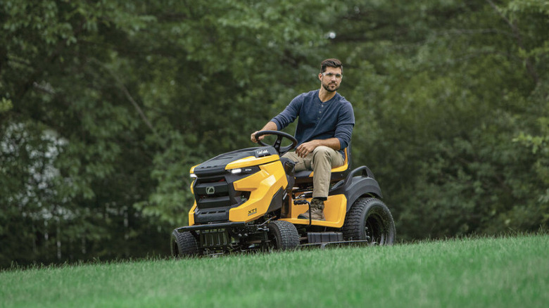 Person riding a Cub Cadet riding lawn mower