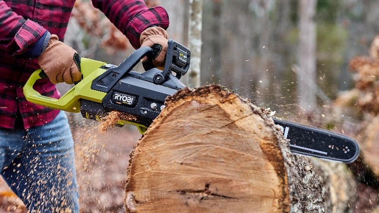 Man cutting log