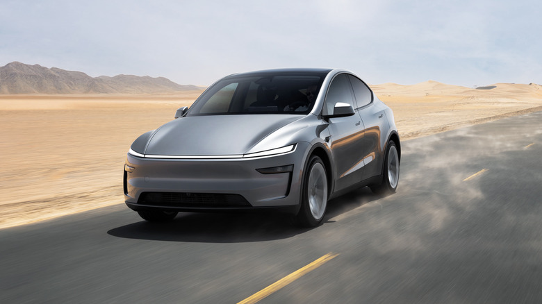 Front 3/4 view of Juniper Tesla Model Y driving through desert