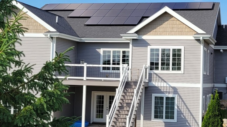 A house with solar panels attached to the roof.