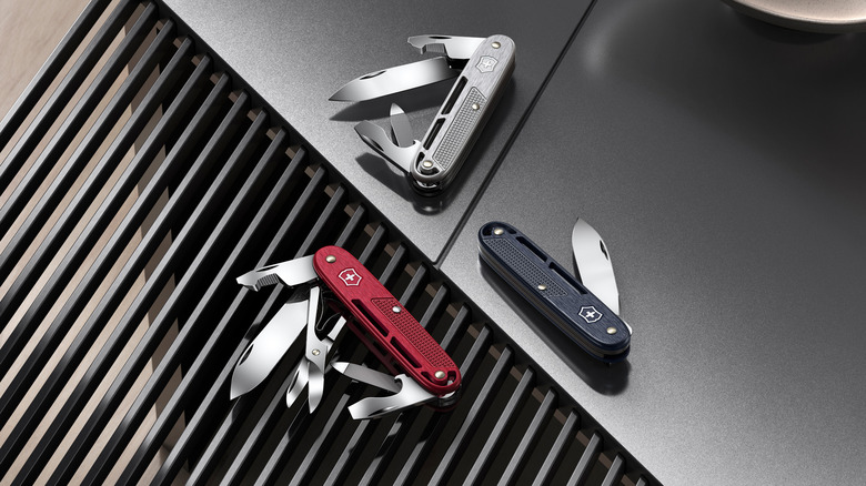 A shot of three Victorinox Alox Swiss army knives