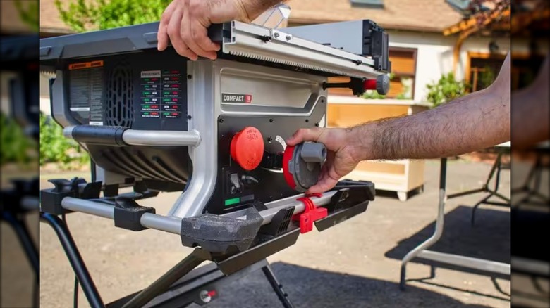 A Man Adjusting The Blade Tilt On SawStop Portable Table Saw