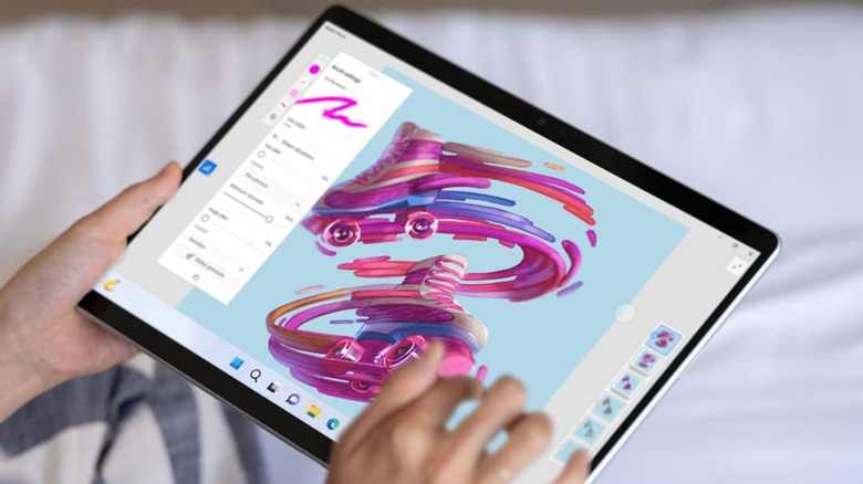 Holding the Microsoft Surface Pro 9