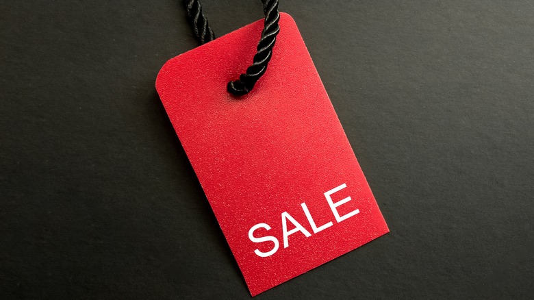 Red sale tag on black background