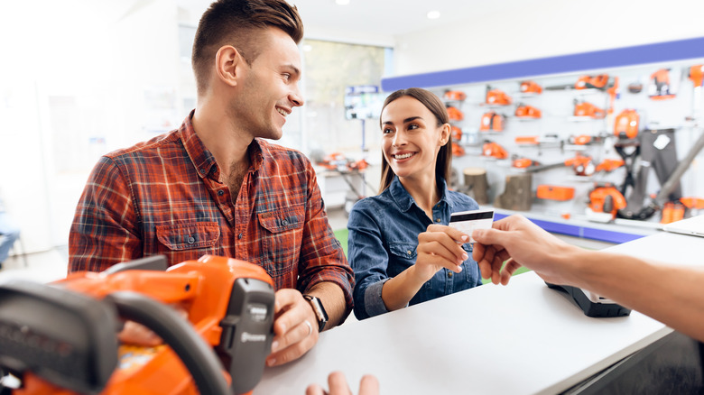 Man and woman buying tool