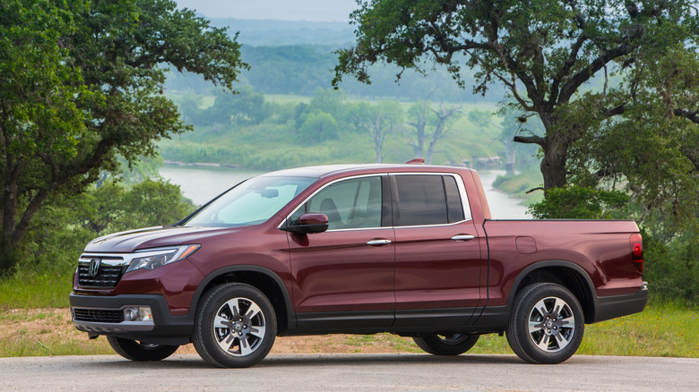 2020 Honda Ridgeline parked in front of woods, left-side view