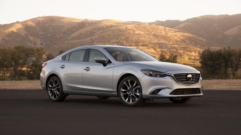 2016 Mazda 6 parked in front of hilly terrain, front-right 3/4 view