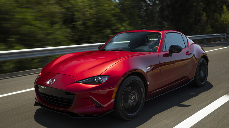 Mazda ND MX-5 Miata driving on road, front-left 3/4 view
