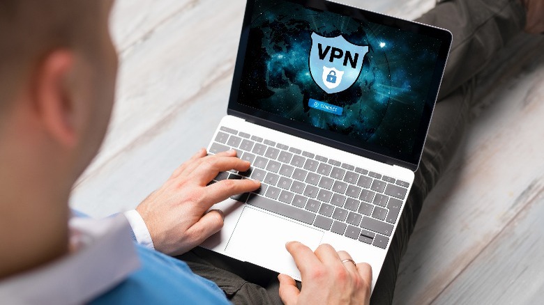 Man using a laptop VPN application