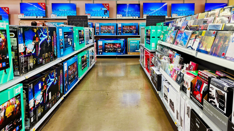 Walmart TV aisle with televisions displayed on wall