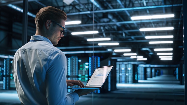 Man with laptop in datacenter