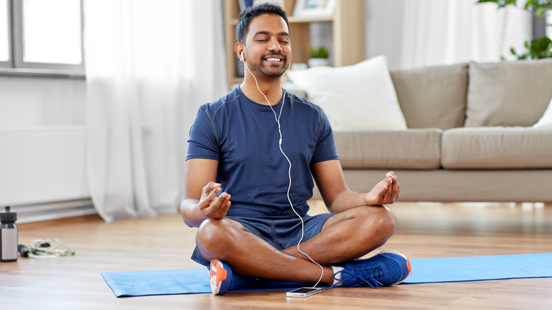 Man meditating with headphones