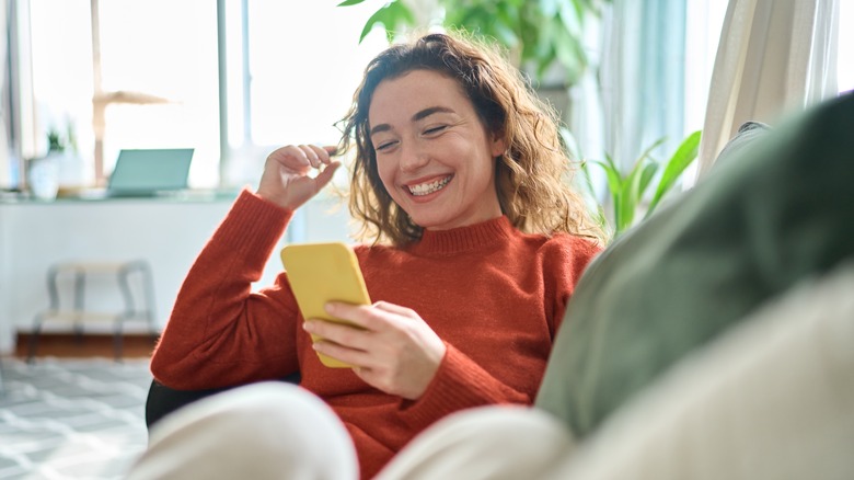 Woman smiling while using phone