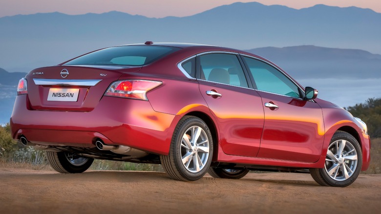 Red 2015 Nissan Altima rear quarter